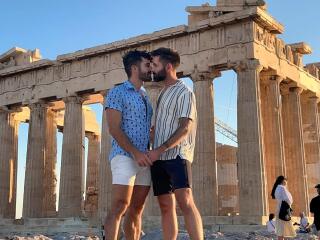 Gay couple kissing at Acropolis in Athens.