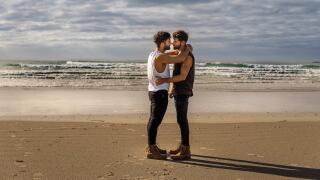 Gay couple on beach in Islay