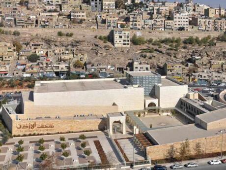 An aerial view of the Jordan Museum in Amman surrounded by buildings.