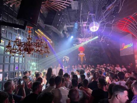 A packed dancefloor under strobe lights at Shamone gay club in Athens.