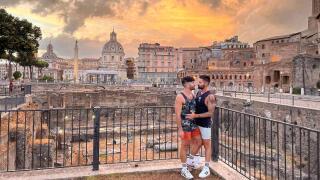 The Nomadic Boys sharing a kiss in front of the Roman Forum and an incredible sunset in Rome.