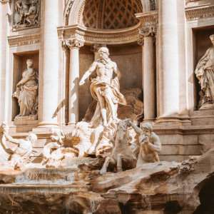 A closeup of the statues above the water at Rome's Trevi Fountain.