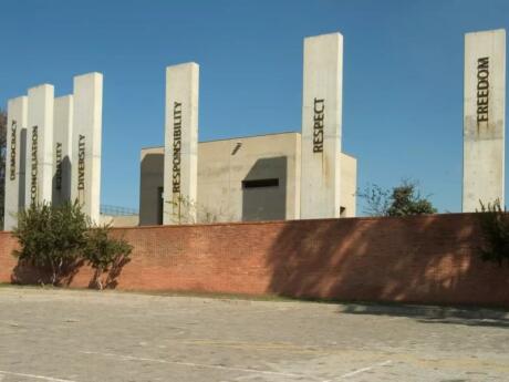 Pillars with words like Responsibility, Freedom, and Respect written on them on the exterior of the Apartheid Museum in Johannesburg.