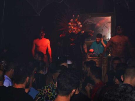 Partygoers watching performers in costume at the Botox Matinee gay Halloween party in Milan.