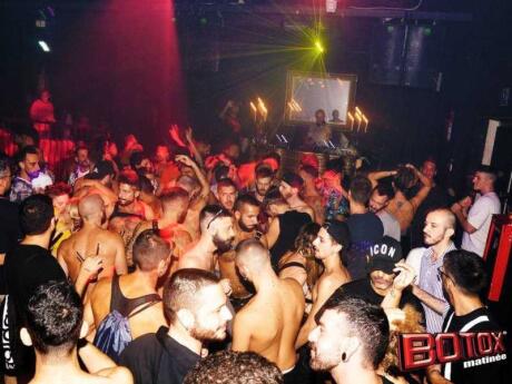 Packed crowd of gay guys at Botox Matinee gay after party club in Milan.