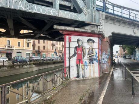 Graffiti on the side of a bridge going over Canal Naviglio Grande in Milan.