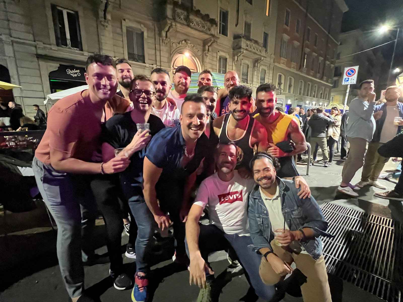 Group of gay guys on the streets of Milan at night.