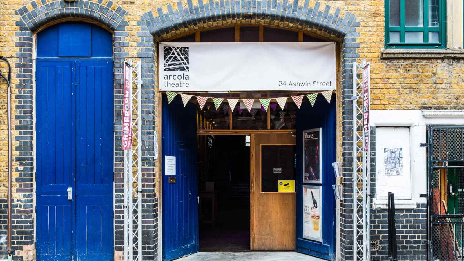 The entrance to the Arcola Theatre in London, with blue doors in a brick building.
