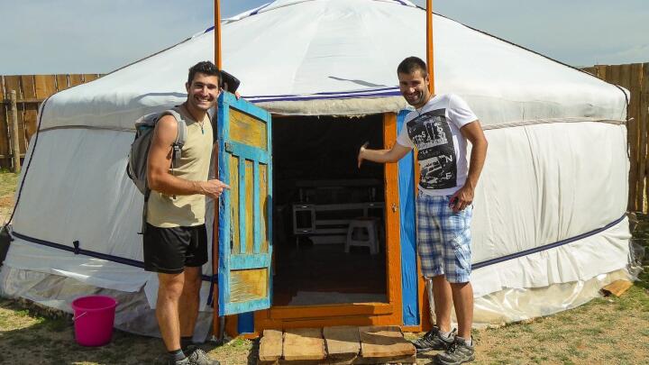 Stef and Seby outside the door of a Mongolian nomadic yurt.