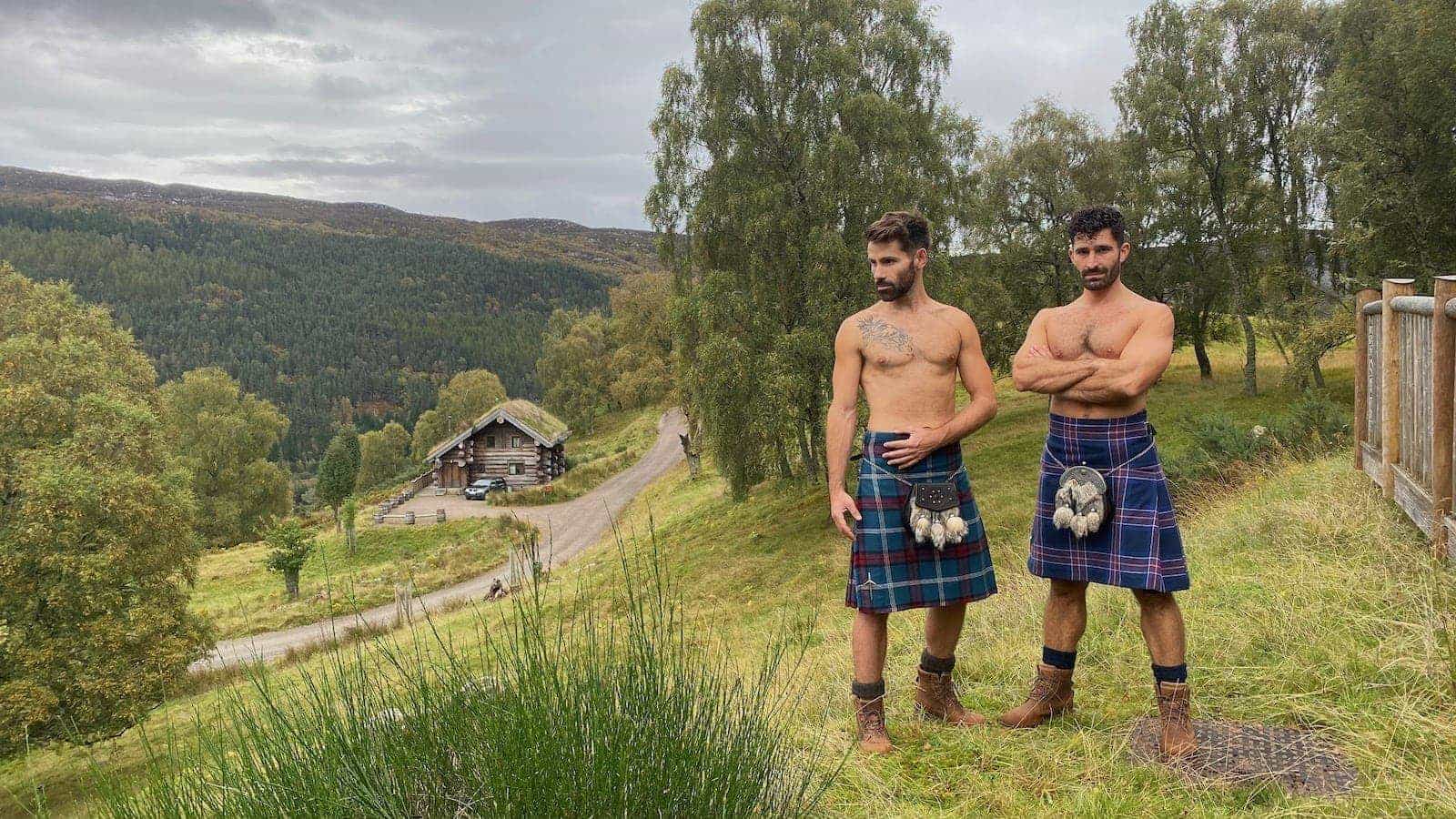 Gay couple in kilts topless at Eagle Brae in the Highlands, Scotland.