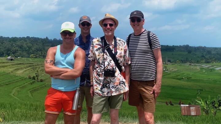 Group of gay men in a rice paddie field.