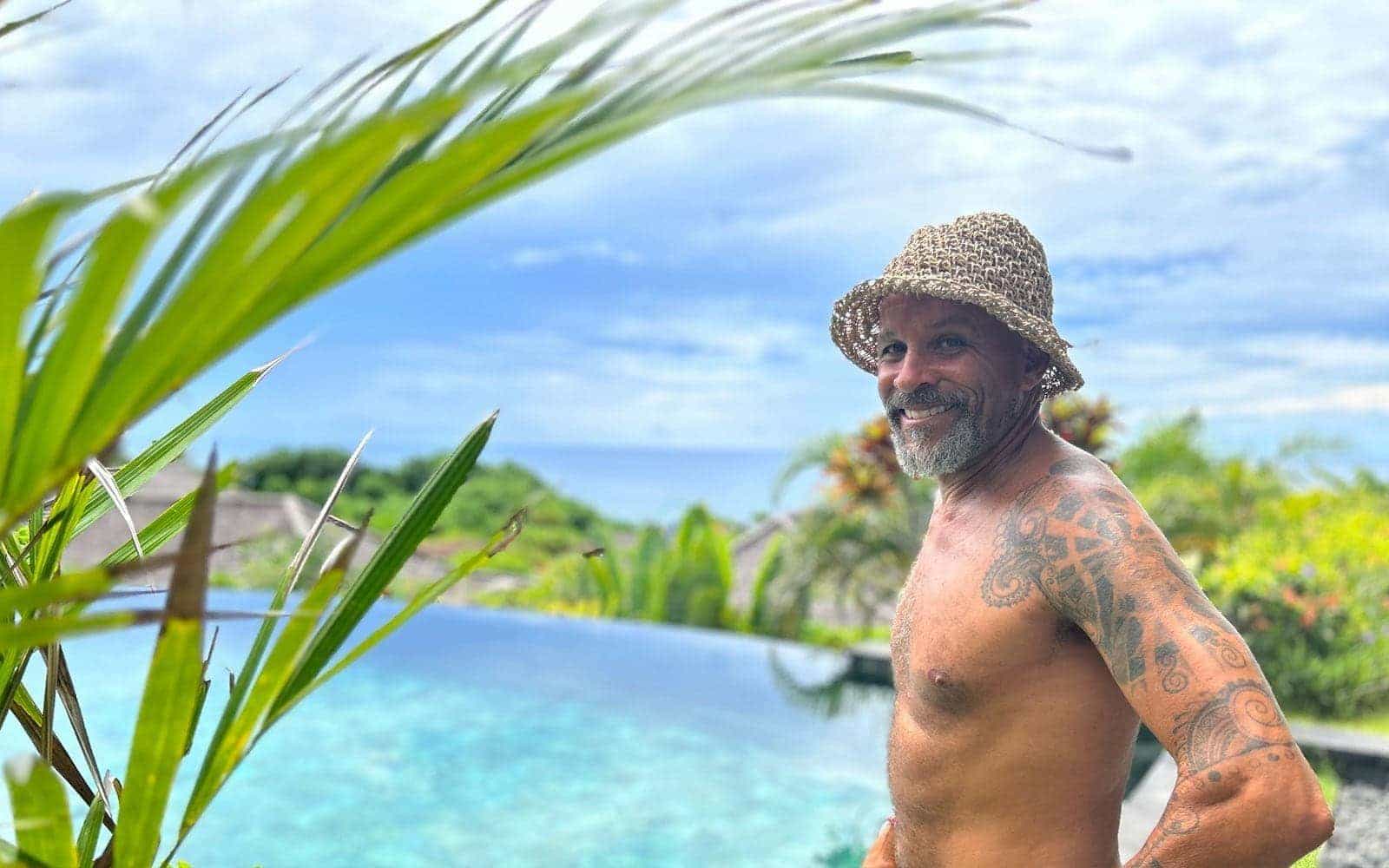 Men next to palm tree in Thailand.