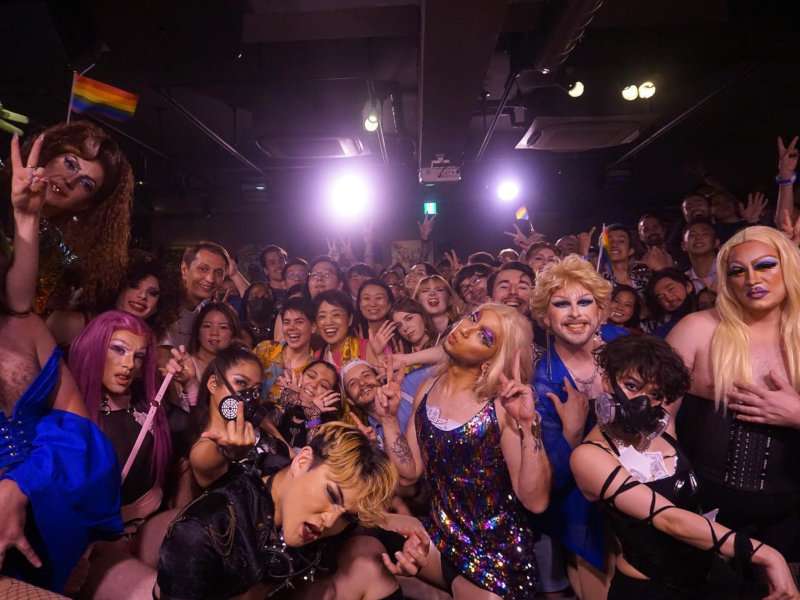 A group of drag queens and partygoers all posing together at a Haus of Kinki event in Osaka.