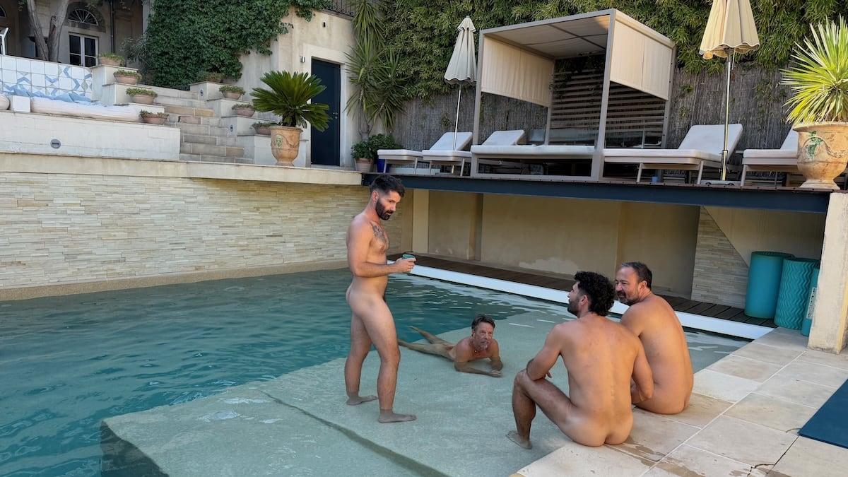 Gay guys hanging out naked at the Naked French Experience Villa pool.