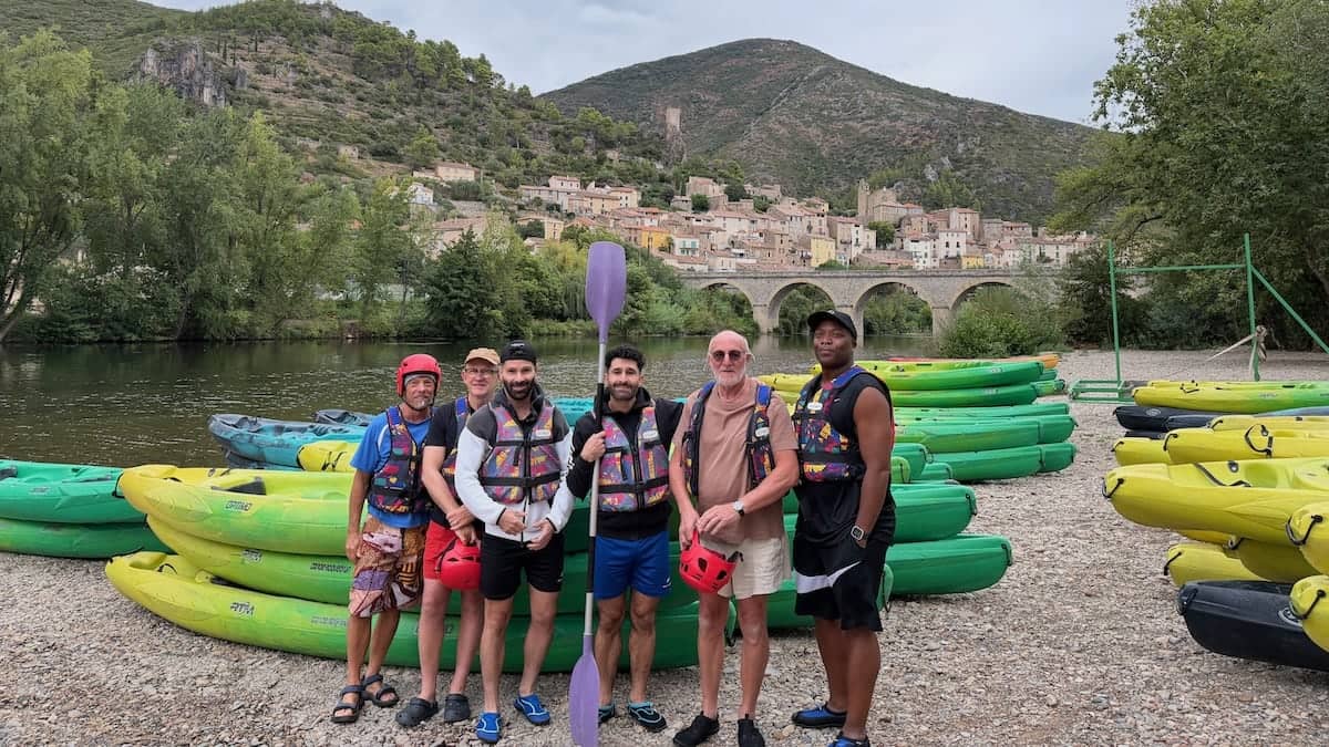 Group of guys kayaking on River Orb in France.
