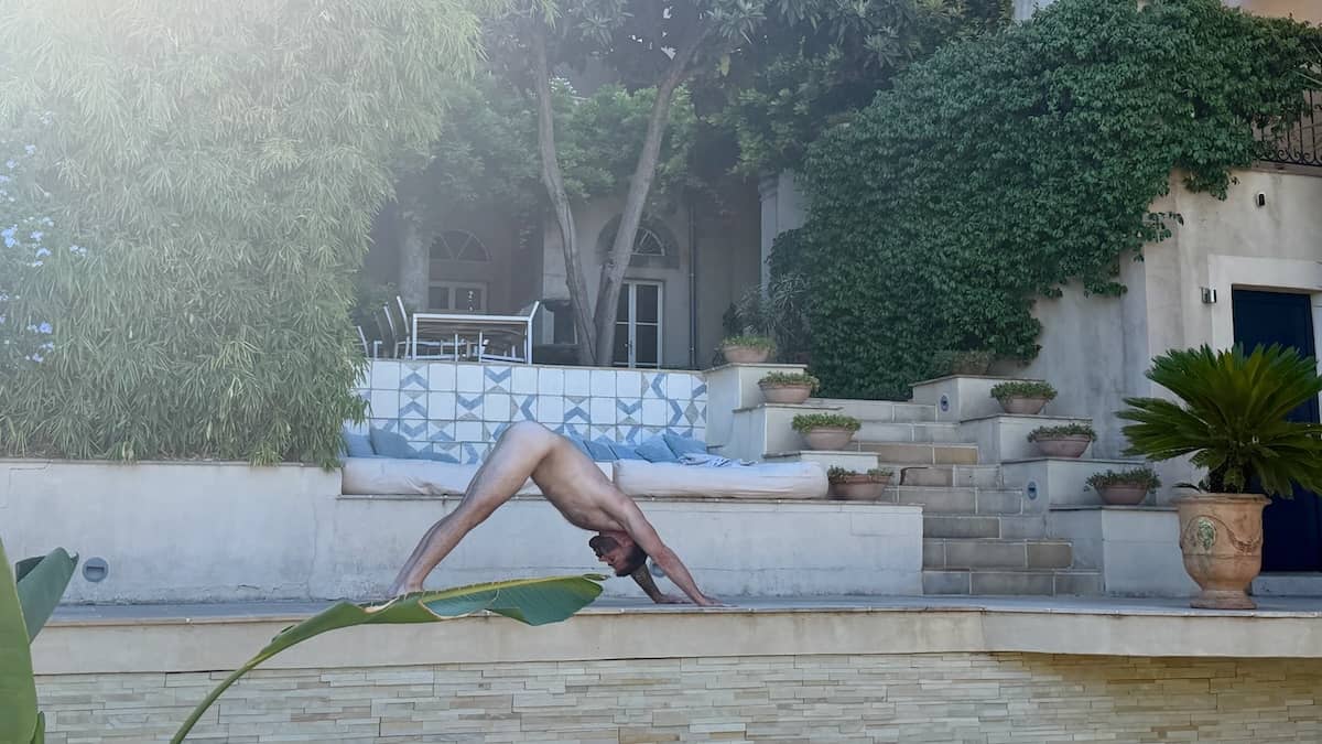 Seby doing a naked downward dog yoga at The Naked French Experience villa.