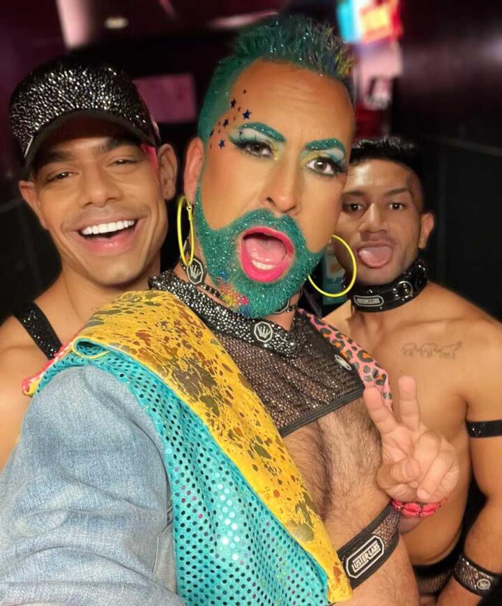 A selfie of Kevin in the City with an amazing aqua beard and makeup with some sexy gogo dancers at Stonewall Hotel in Sydney.