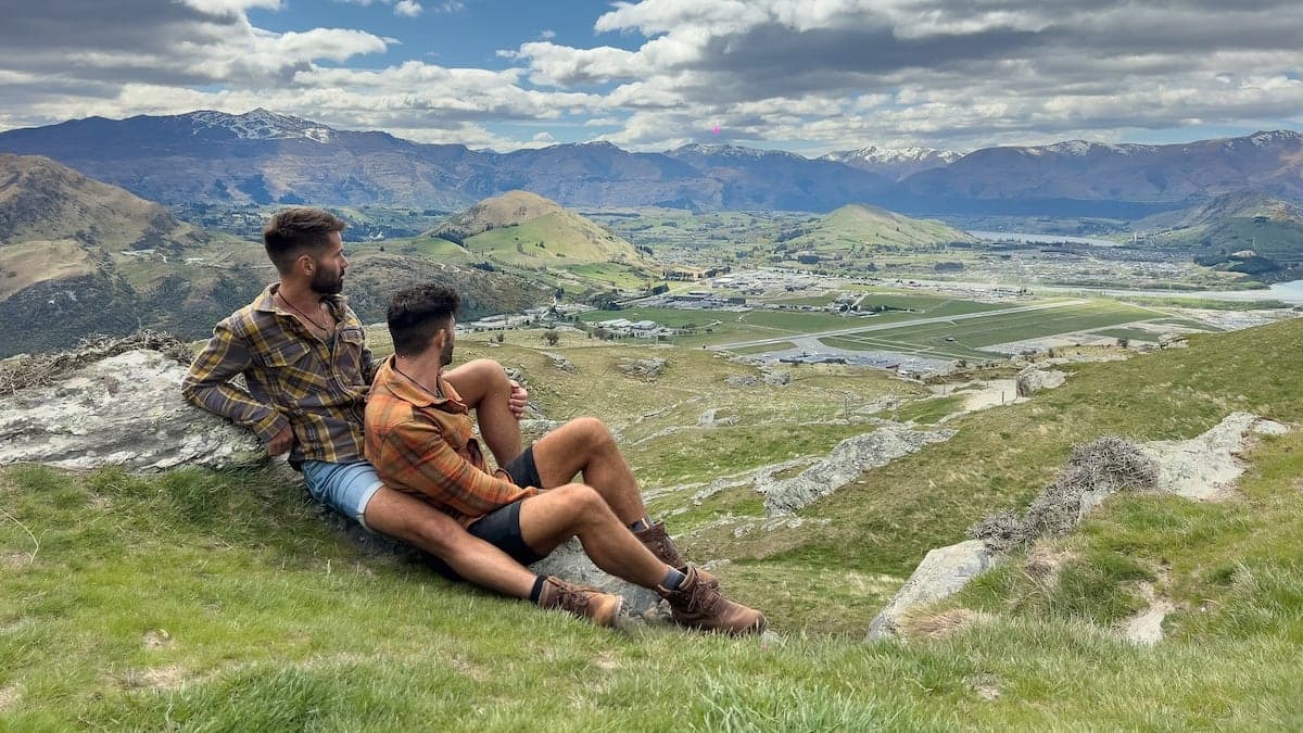 Gay couple embracing at the Deer Park Heights in Queenstown in New Zealand.