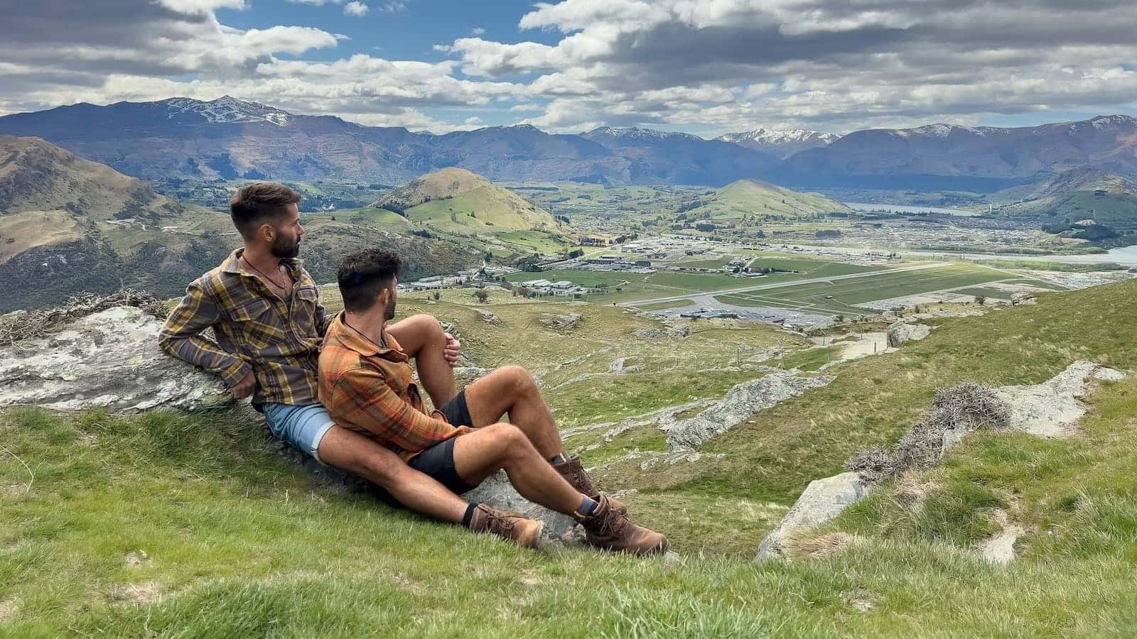 Gay couple romantic embrace at Deer Park Heights in Queenstown, New Zealand.