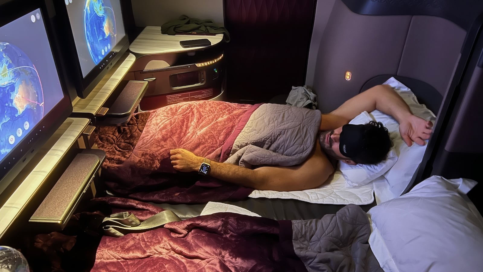 Stefan enjoying our private Qsuite in Qatar Business Class from Auckland to Doha.