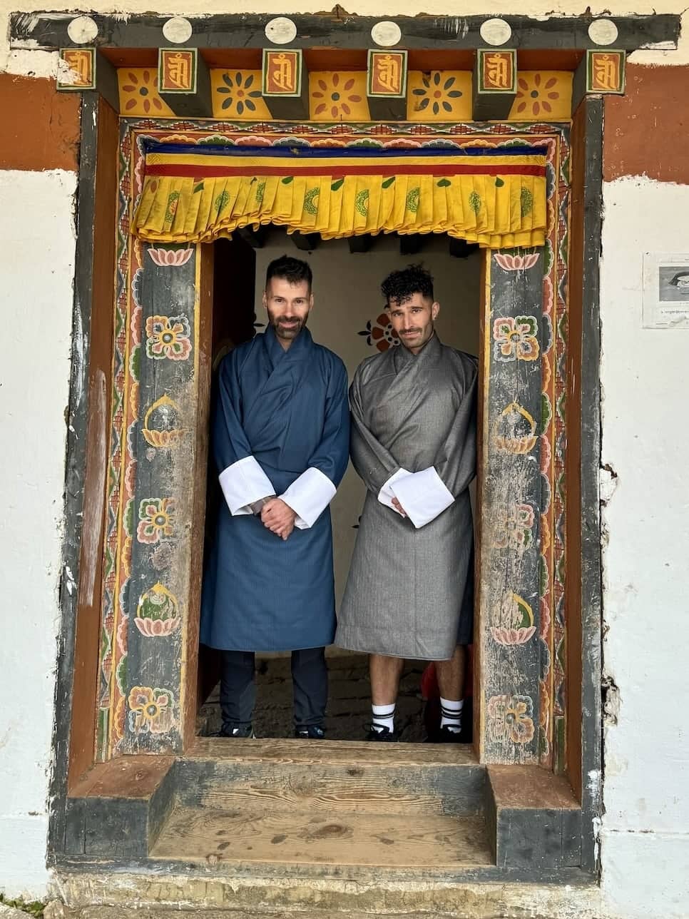 Gay couple wearing gho Bhutan traditional dress at the Punakha Sobsokha.
