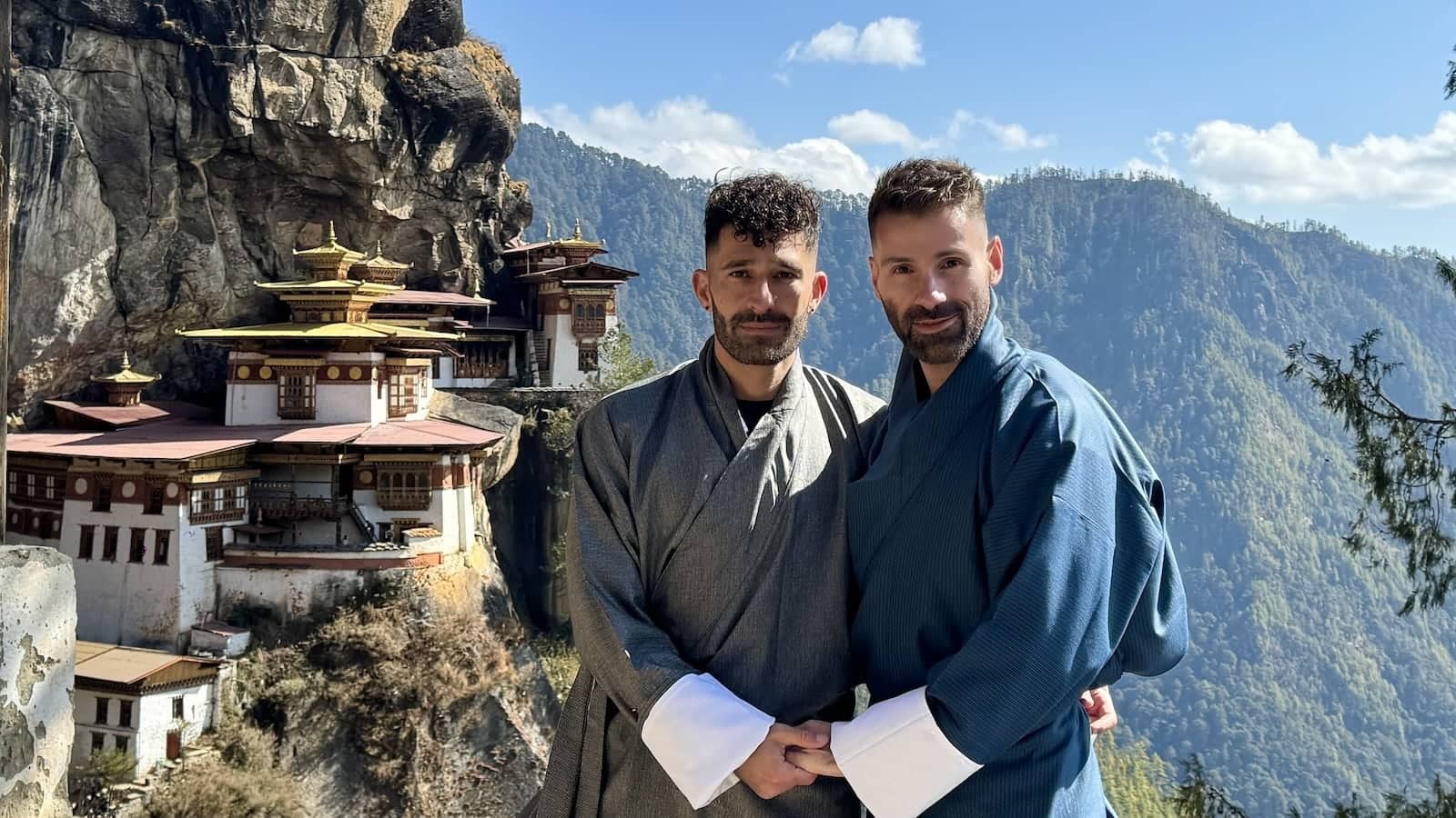 Gay couple holding hands at TIger's Nest Monastery in Bhutan.