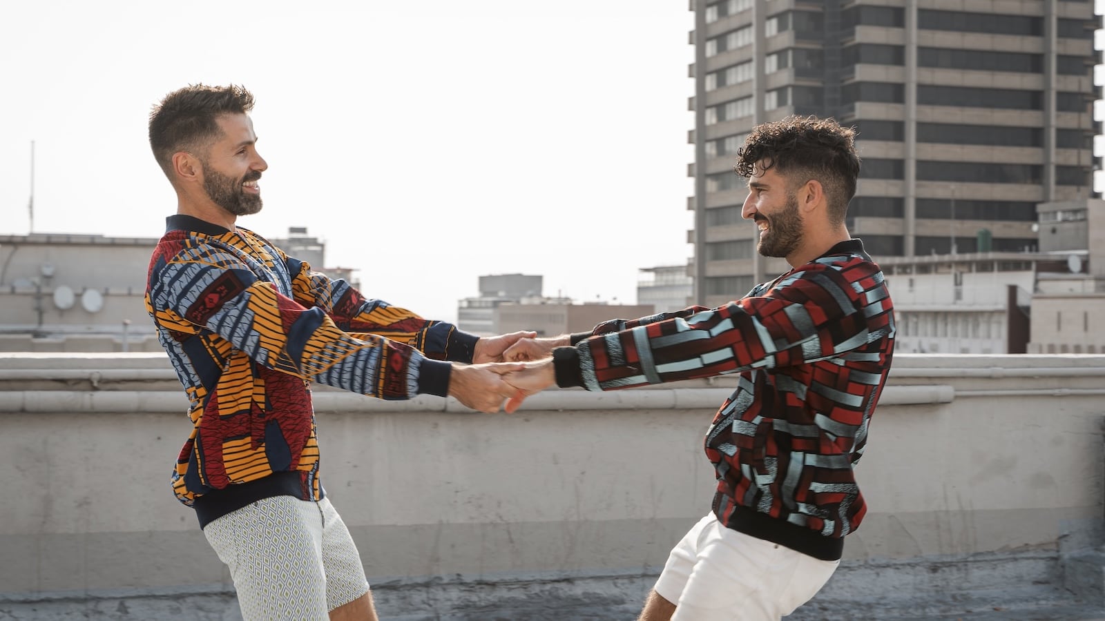 Gay couple dancing wearing their Caraci Clothing African jackets in Johannesburg.