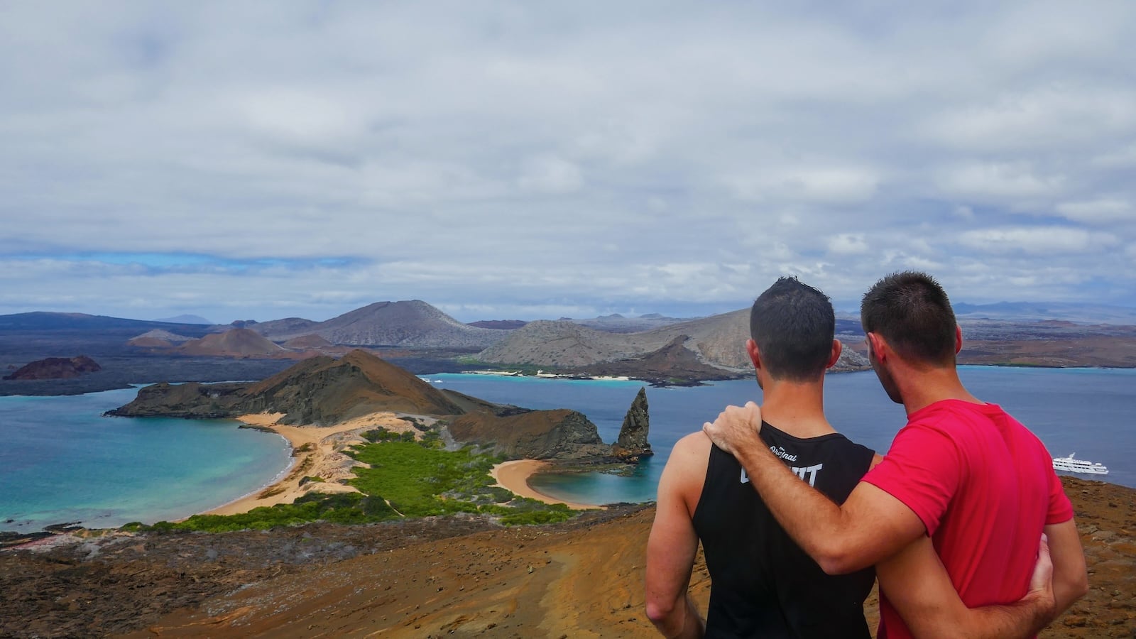 Gay couple at Bartolome Island in the Galapagos Islands.