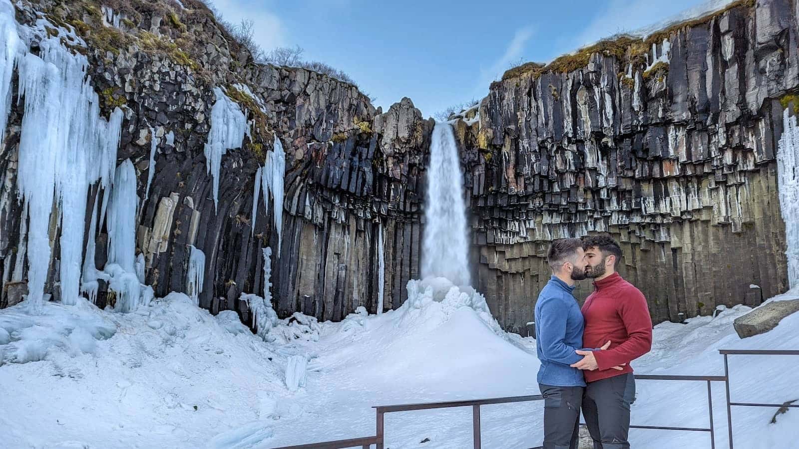 Gay couple at Svartifoss waterfall at Skaftafell National Park.