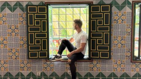 Stefan sitting at a window in the Ahmed Bey Palace of Constantine.