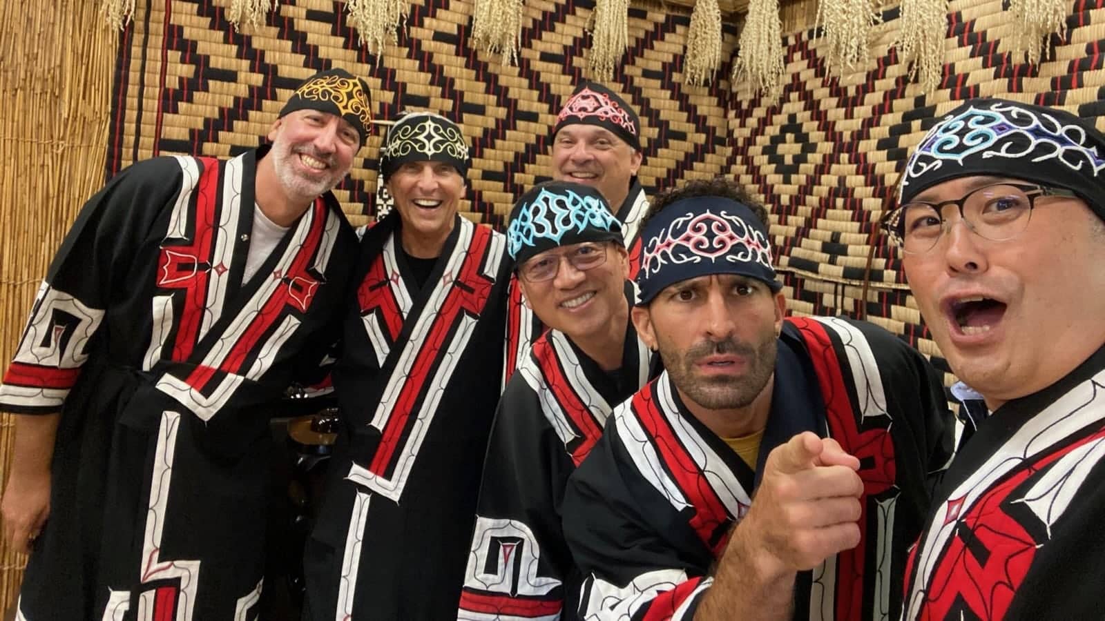 Stefan and five other men posing for a photo all while wearing traditional Ainu clothing on Hokkaido.