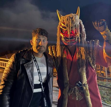 Stefan looking worried next to a person in a Japanese demon costume.