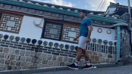 Stefan walking along a steep road in Bukchon Hanok Village.