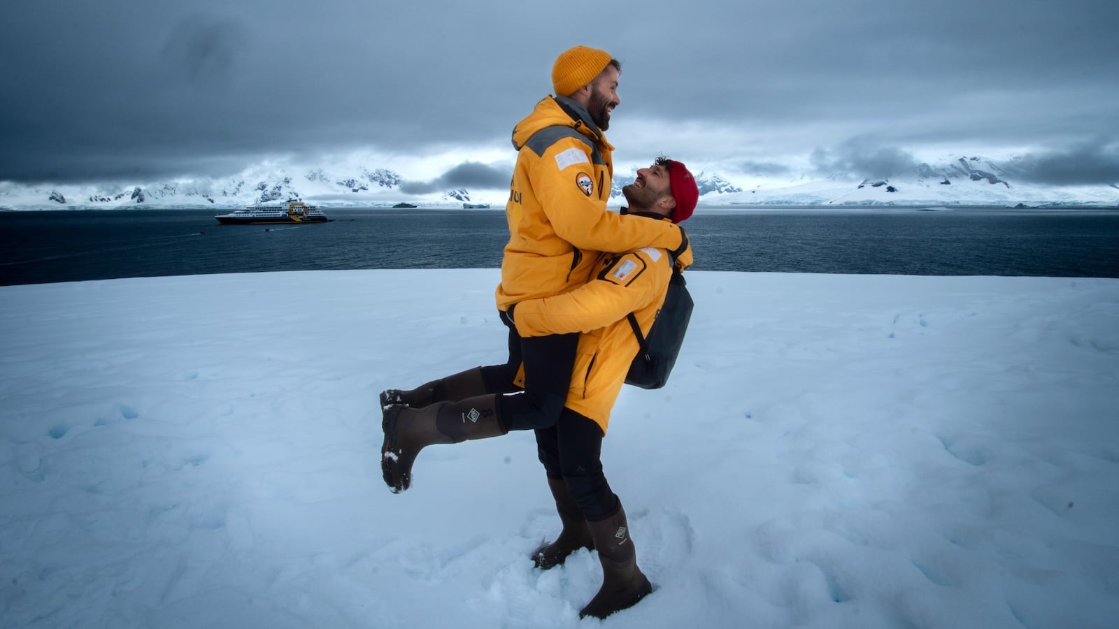 Gay couple embracing at Portal Point on the Antarctica Peninsula.