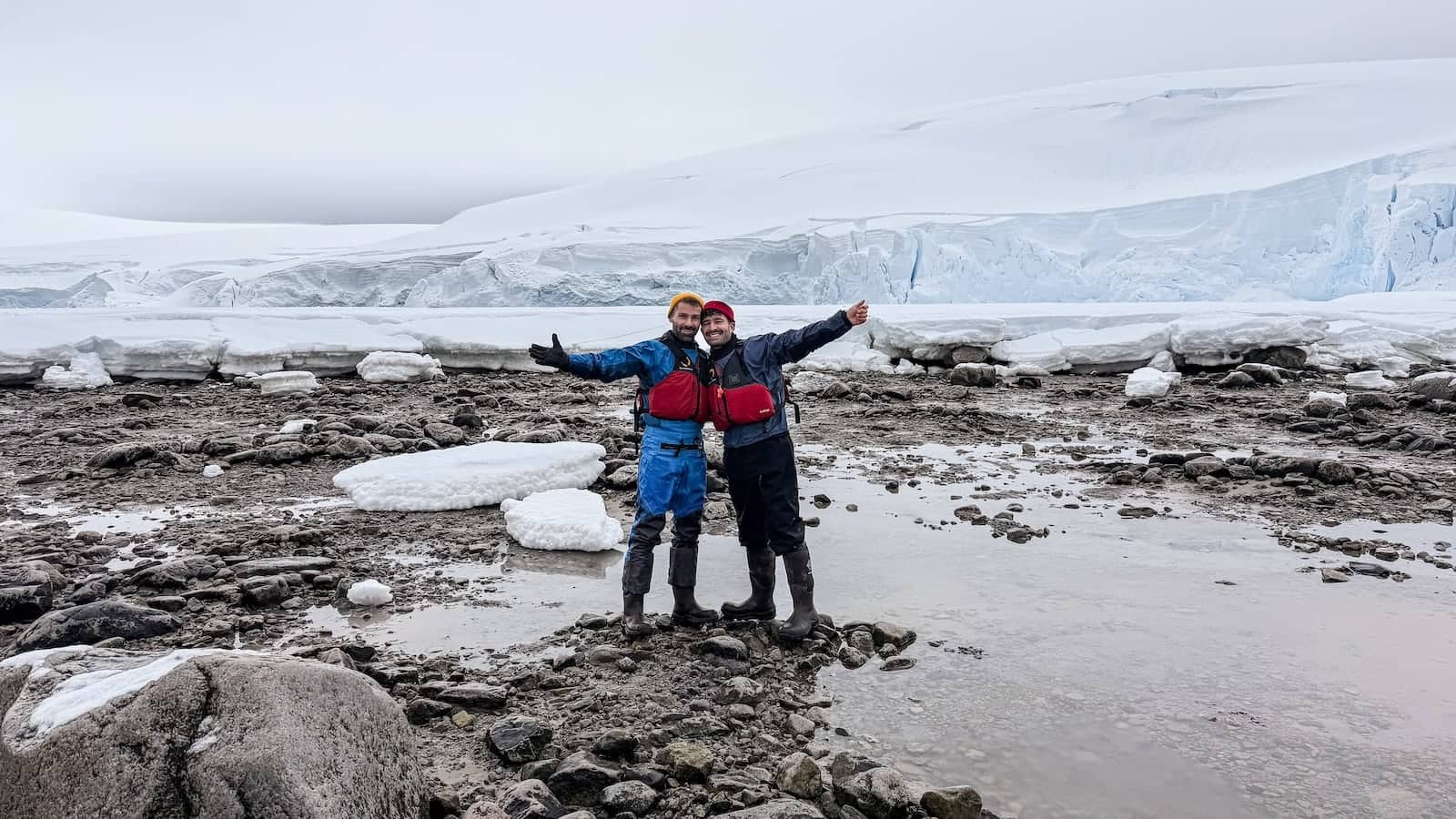 Gay couple expressing joy on the Antarctica Peninsula.