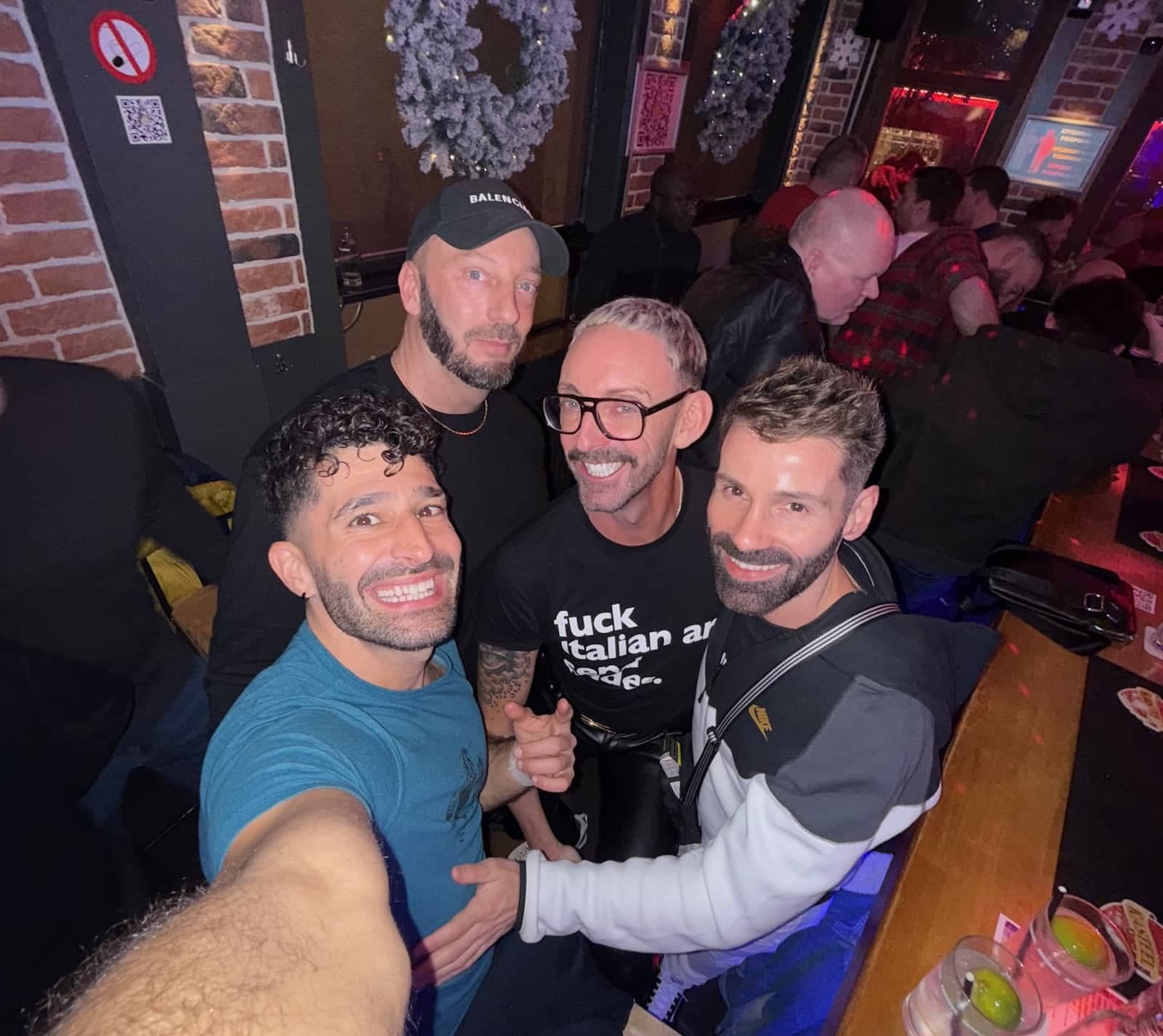 Stefan and Seby posing with some friends in a bar.