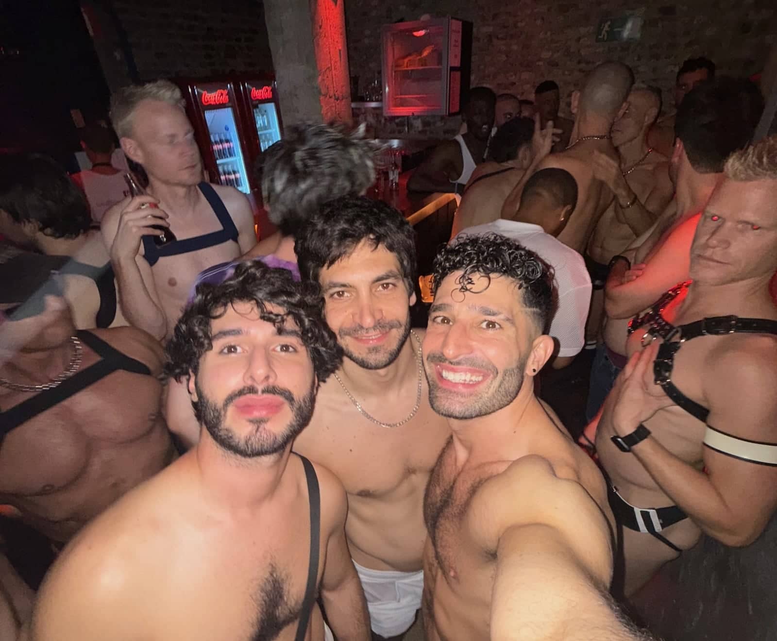 Stefan and some friends posing for photos in a gay club where everyone is topless...