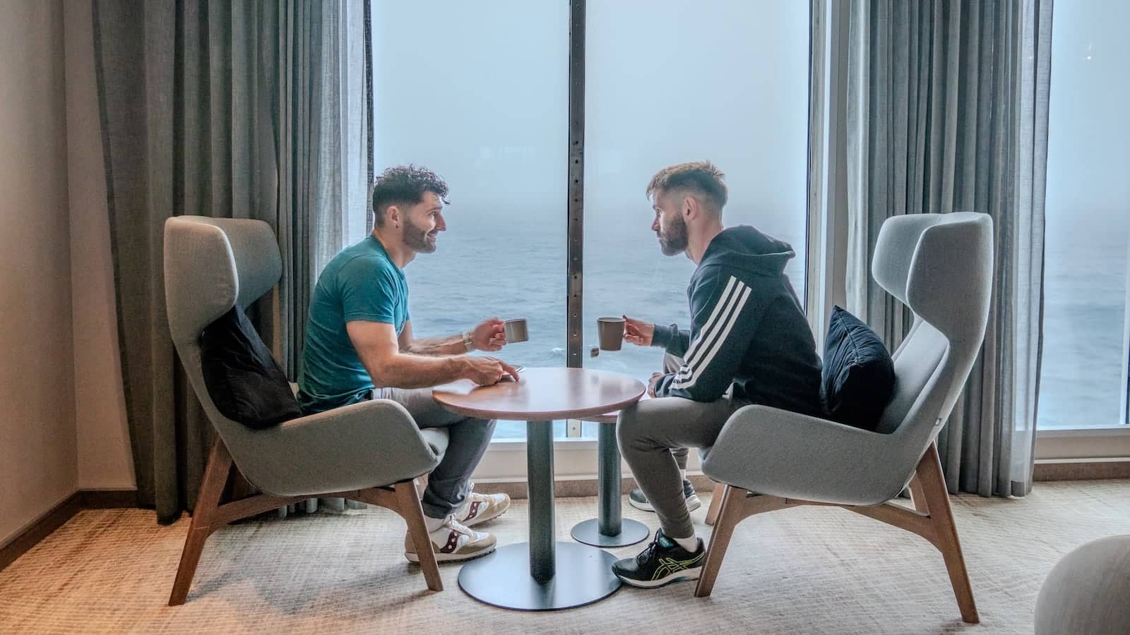 Gay couple having a cup of tea on the Ultramarine Ship.