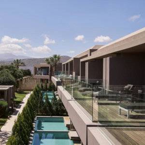 A hotel with spacious balconies looking out over small private pools.