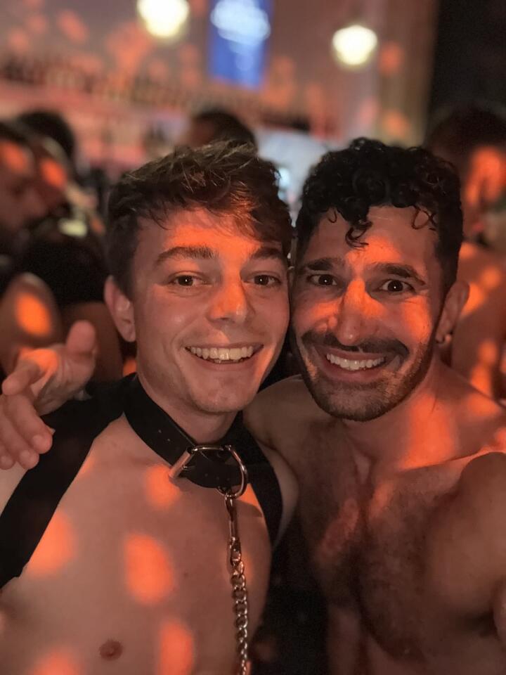 Stefan and a friend wearing a collar and lead both topless at a party.