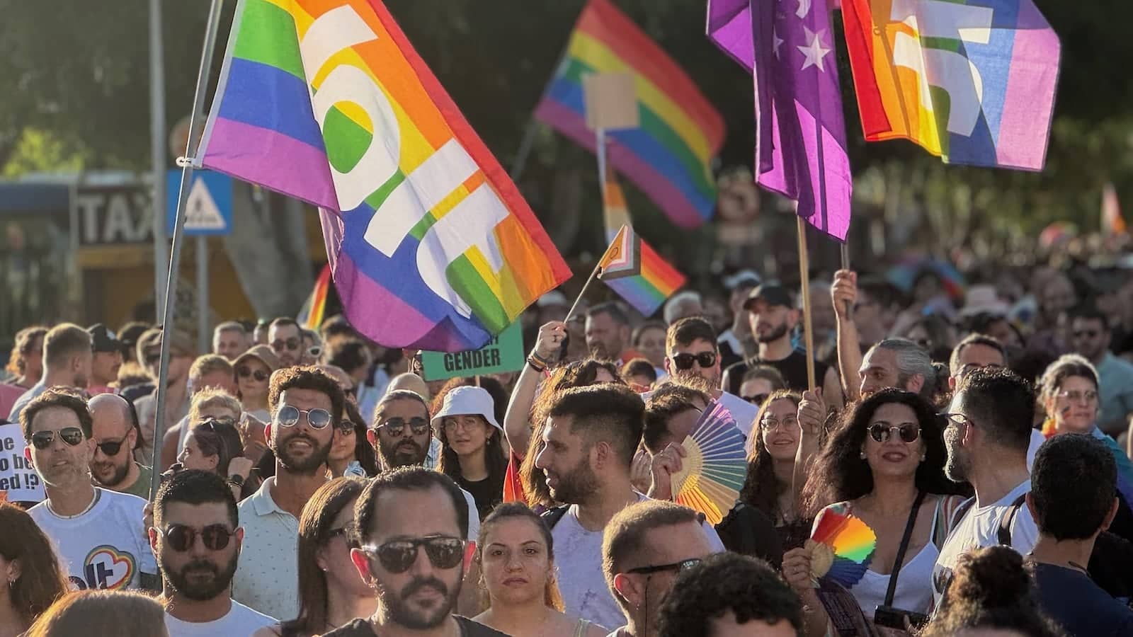 Pride Parade with rainbow flags.