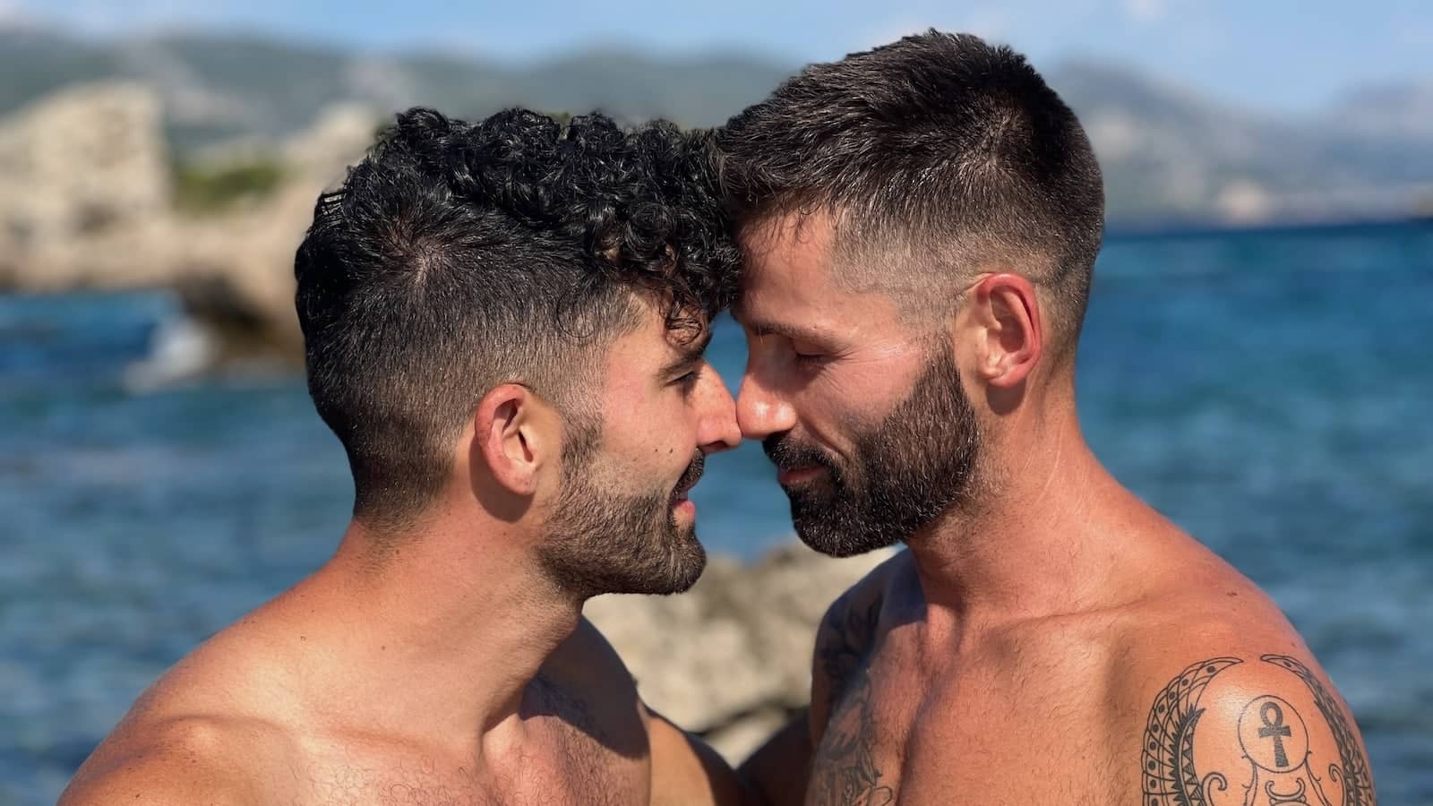 Gay couple beach kiss in Dubrovnik.