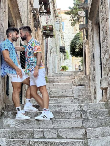 Gay couple embrace in the stairs of Dubrovnic.