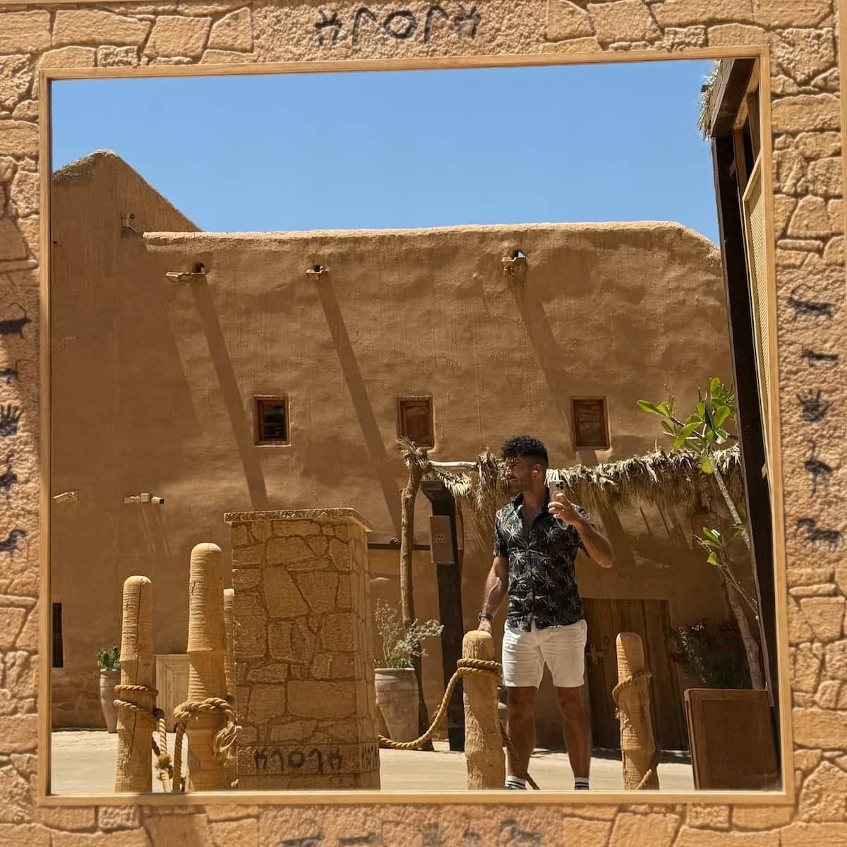 Stefan taking a mirror selfie at the Old Town of Al Ula in Saudi Arabia.