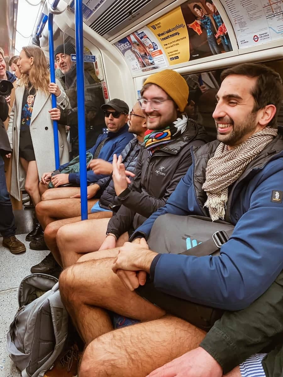 Group of men in the London Underground tube part of the No Trousers Tube Ride.