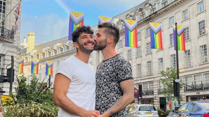 Regent Street rainbows and gay couple kissing.