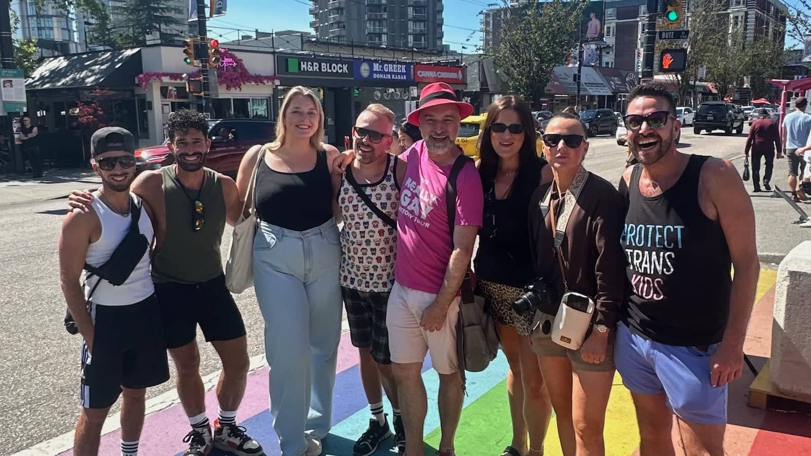 Gay group on Davie Street Rainbow crossing in Vancouver gay village.