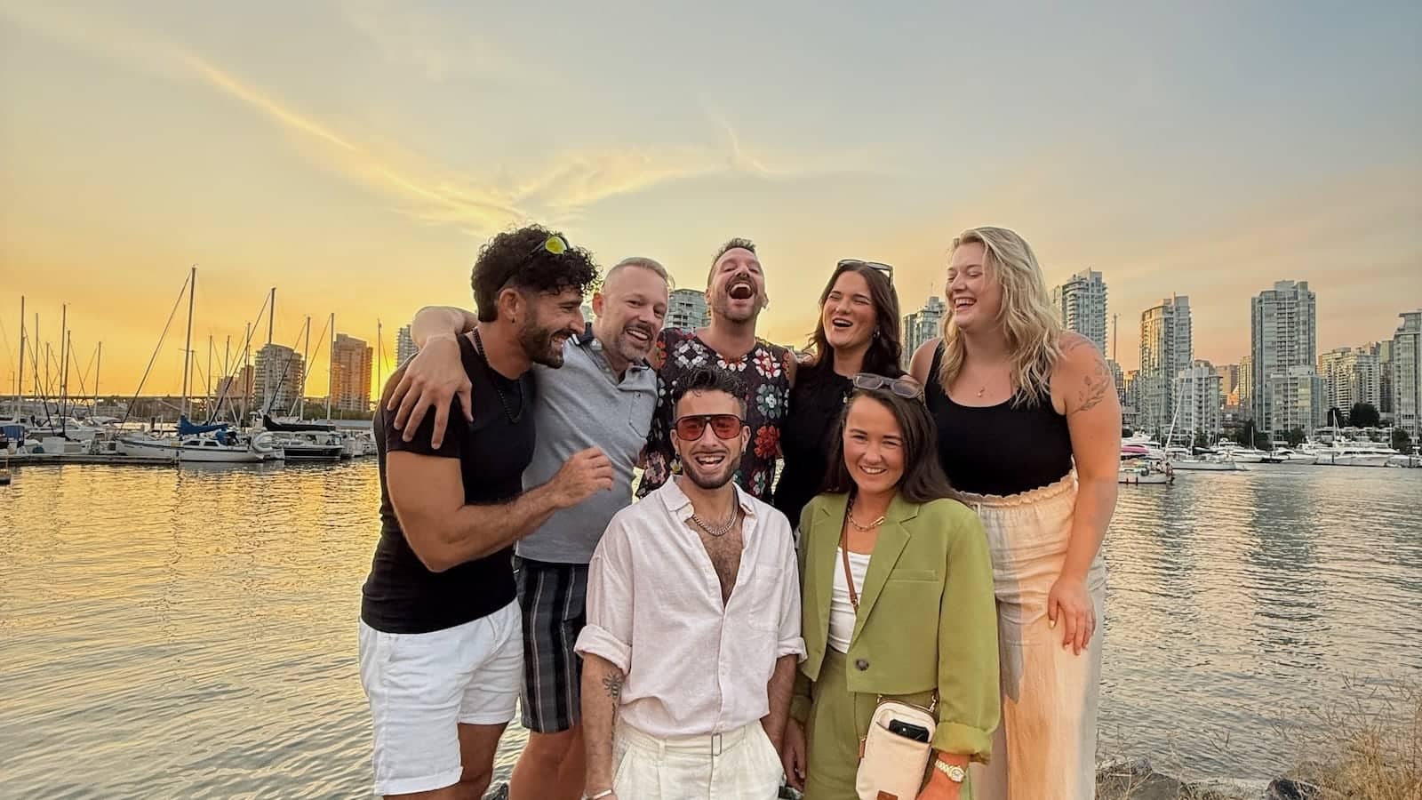 Gay group with the Vancouver skyline at sunset.