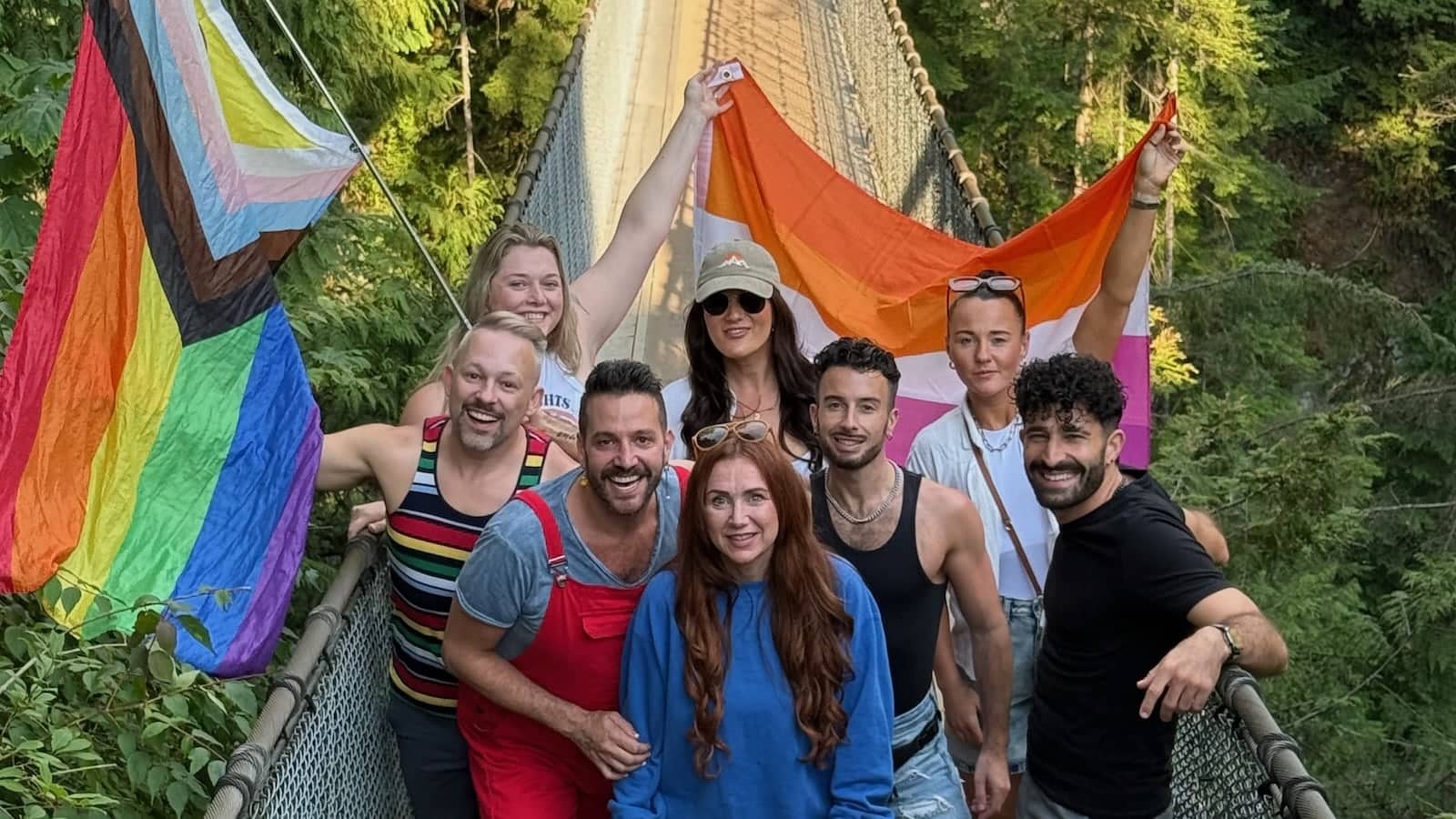 Vancouver Pride gay group with rainbow flag at Capilano Suspension Bridge.