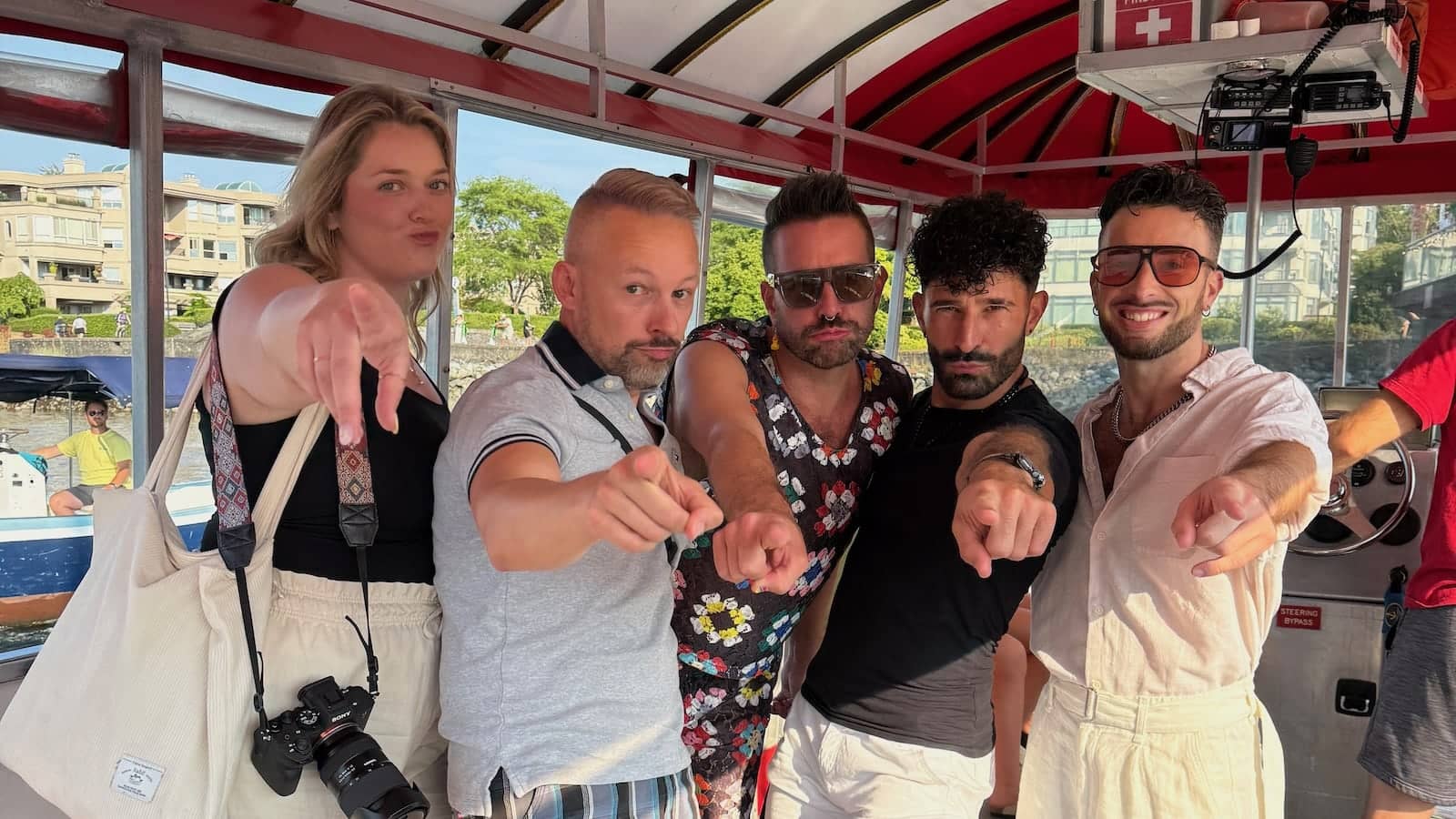 Gay group pointing at the camera for Vancouver Pride.
